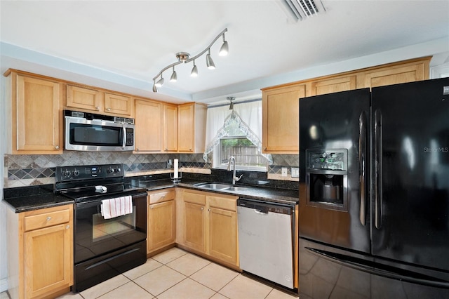 kitchen with light tile patterned floors, sink, backsplash, black appliances, and dark stone countertops