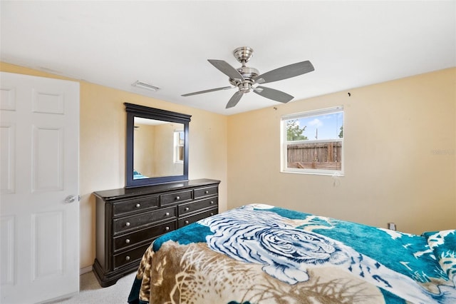 bedroom featuring light carpet and ceiling fan