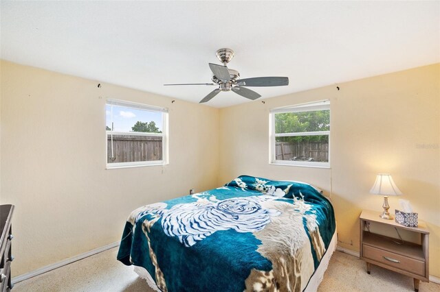 bedroom featuring ceiling fan and light carpet