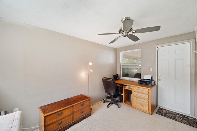 carpeted office space with ceiling fan