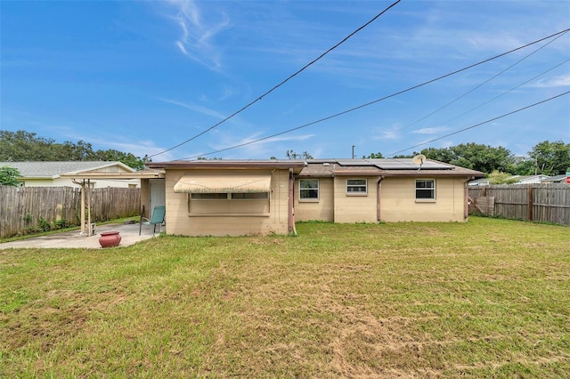 back of property with a patio and a yard