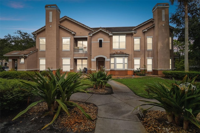 view of front of house featuring a balcony