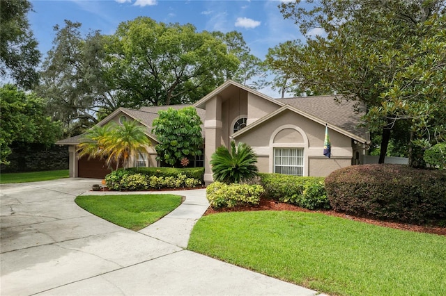 view of front of property with a front lawn and a garage