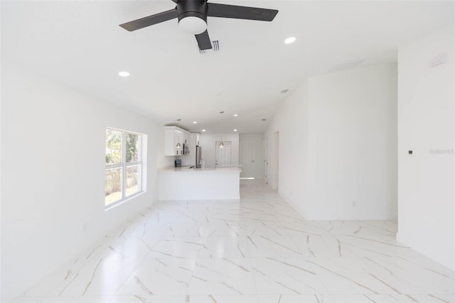 unfurnished living room featuring ceiling fan