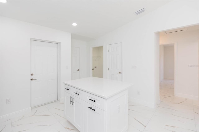 interior space featuring a center island and white cabinets