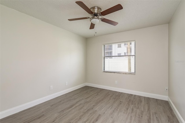 unfurnished room with light hardwood / wood-style floors, ceiling fan, and a textured ceiling