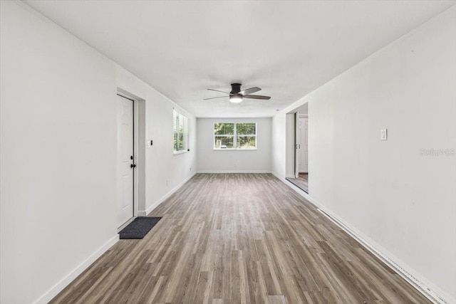 empty room with ceiling fan and hardwood / wood-style flooring