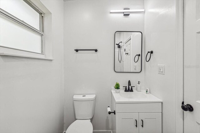 bathroom featuring toilet and vanity