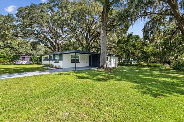 view of front of house with a front lawn and stucco siding