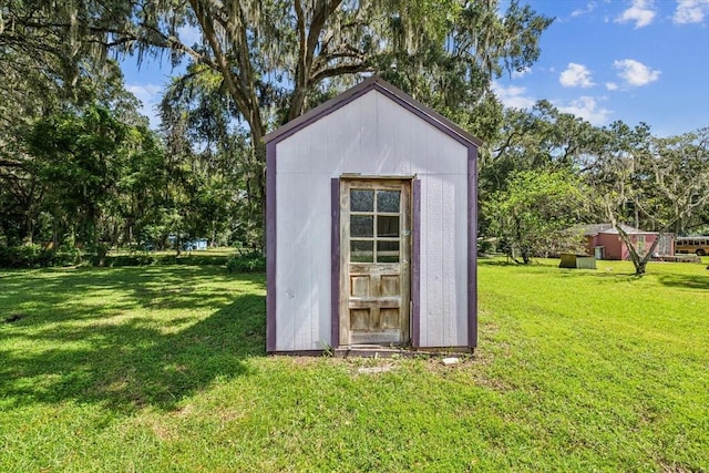 view of outbuilding featuring a yard