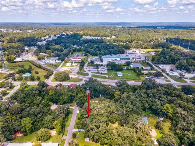 birds eye view of property with a wooded view