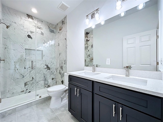 bathroom featuring toilet, a shower with door, and vanity