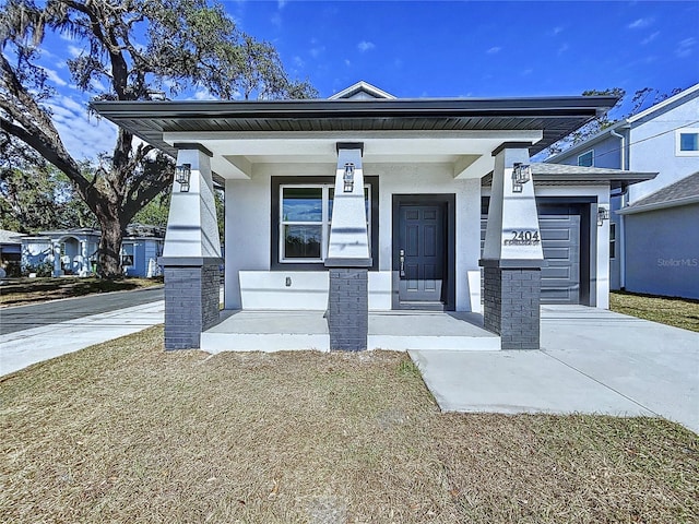 view of front facade featuring a porch and a garage