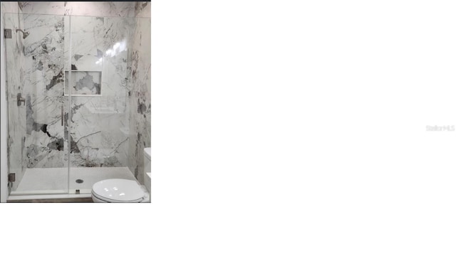 full bath with toilet and a marble finish shower