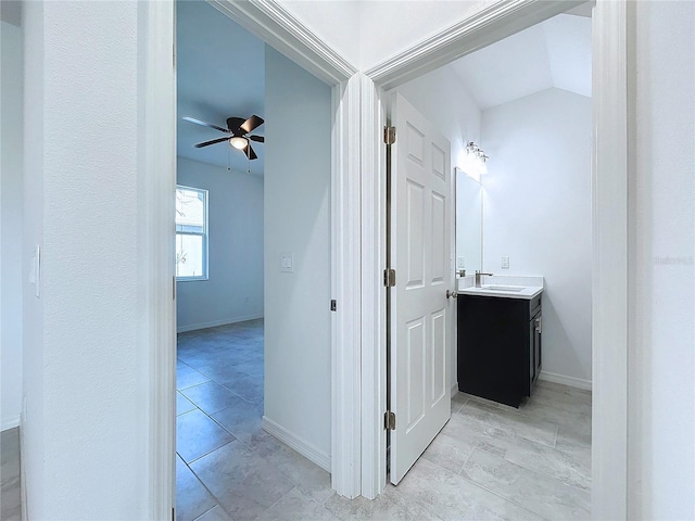 bathroom with a ceiling fan, tile patterned flooring, vanity, and baseboards