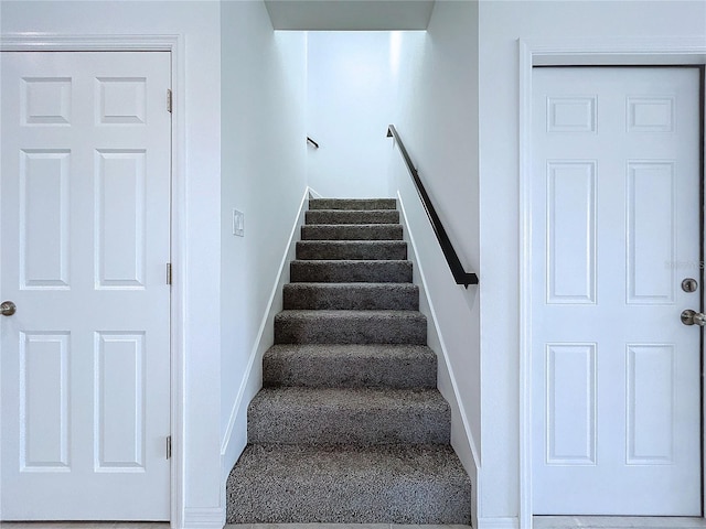 stairway featuring baseboards