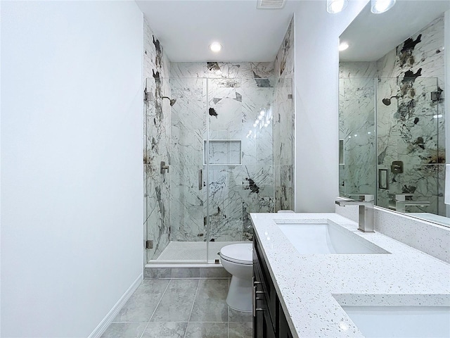 bathroom featuring double vanity, a marble finish shower, baseboards, toilet, and a sink