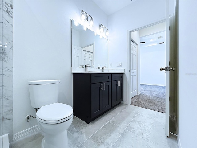 full bathroom featuring toilet, vanity, and baseboards