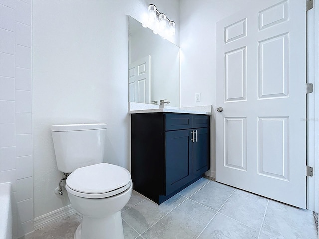 full bath featuring toilet, tile patterned floors, baseboards, and vanity