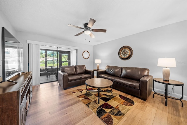 living room with ceiling fan and light wood-type flooring