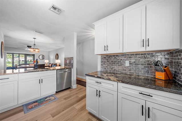 kitchen featuring dishwasher, white cabinets, sink, hanging light fixtures, and ceiling fan