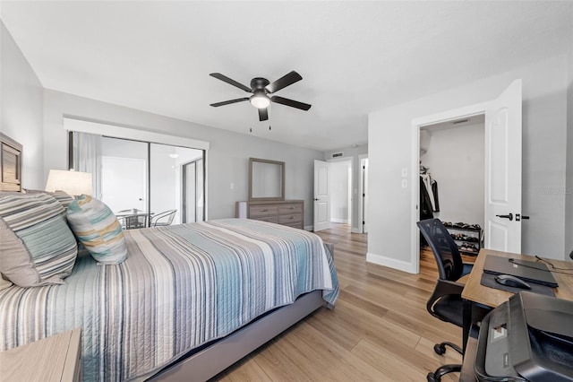 bedroom featuring a closet, ceiling fan, and light hardwood / wood-style flooring