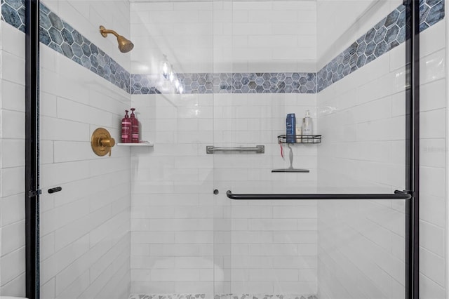 bathroom featuring a shower with door