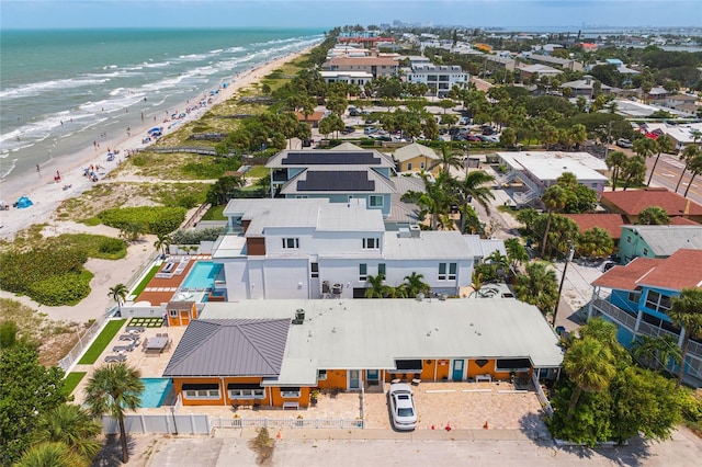 drone / aerial view with a water view and a beach view