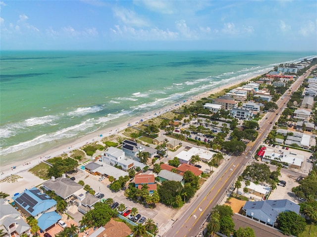 drone / aerial view with a water view and a beach view