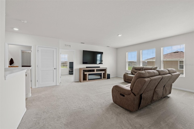 carpeted living room with a fireplace