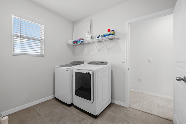 clothes washing area with light tile patterned floors and independent washer and dryer