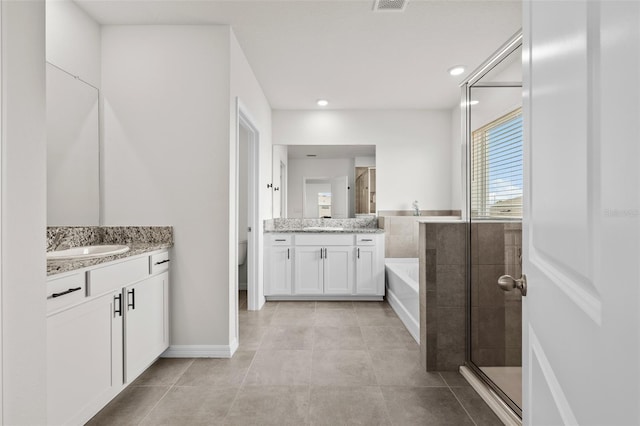 full bathroom with shower with separate bathtub, tile patterned flooring, vanity, and toilet