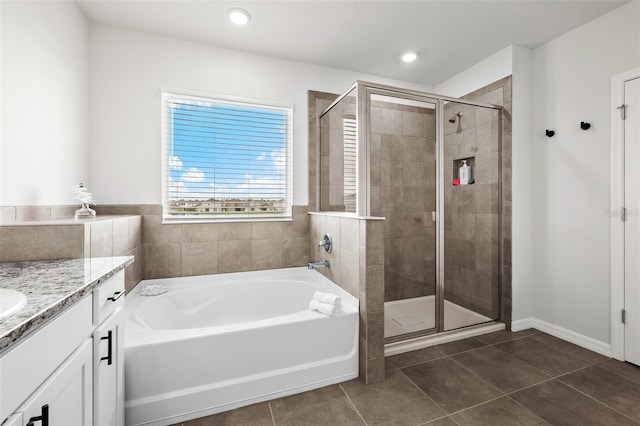 bathroom featuring shower with separate bathtub, tile patterned flooring, and vanity