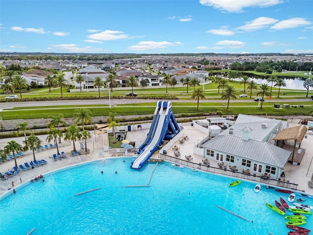 view of swimming pool featuring a water view and a water slide