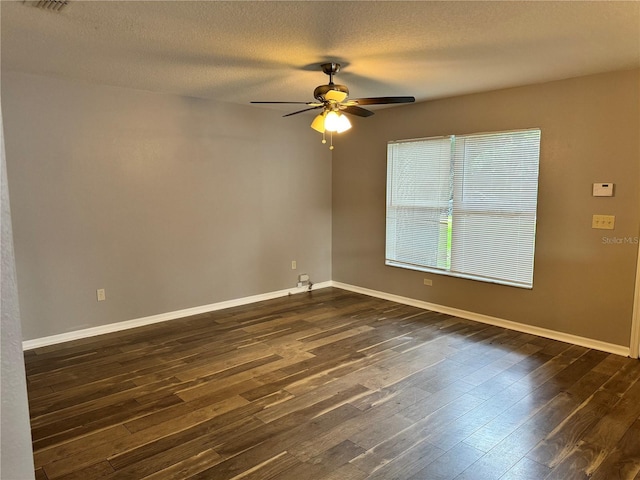 empty room featuring a textured ceiling, dark hardwood / wood-style flooring, and ceiling fan