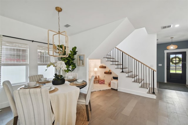 dining area featuring dark hardwood / wood-style flooring and a notable chandelier