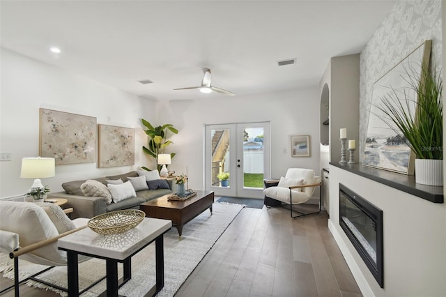 living room with hardwood / wood-style flooring, ceiling fan, and french doors