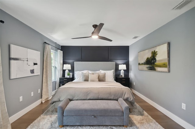 bedroom with ceiling fan and dark hardwood / wood-style flooring