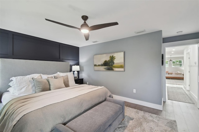 bedroom with light hardwood / wood-style flooring and ceiling fan