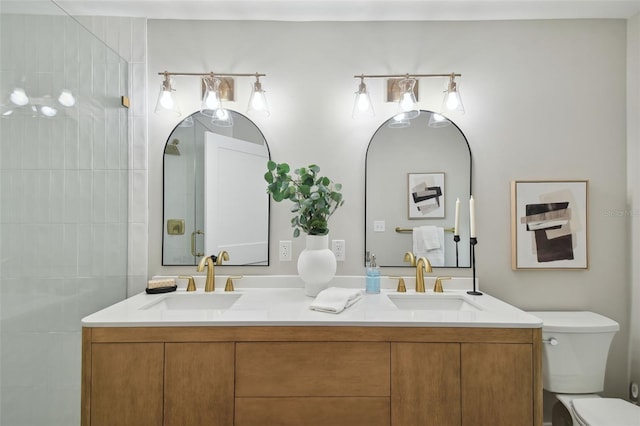 bathroom featuring tiled shower, vanity, and toilet