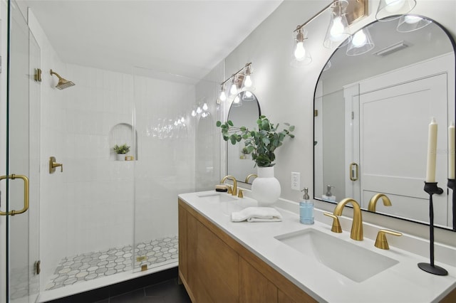 bathroom featuring tile patterned floors, vanity, and walk in shower