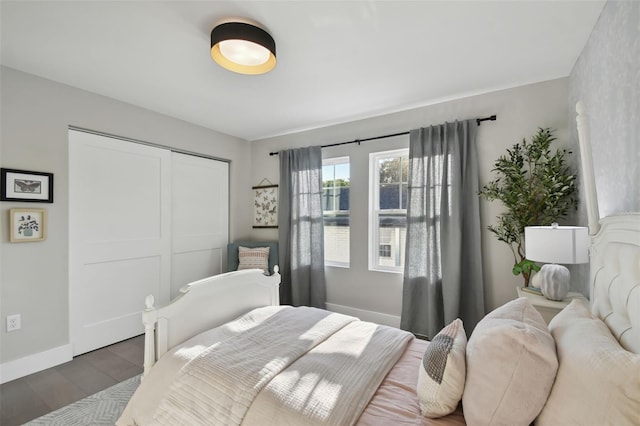 bedroom with a closet and dark hardwood / wood-style floors