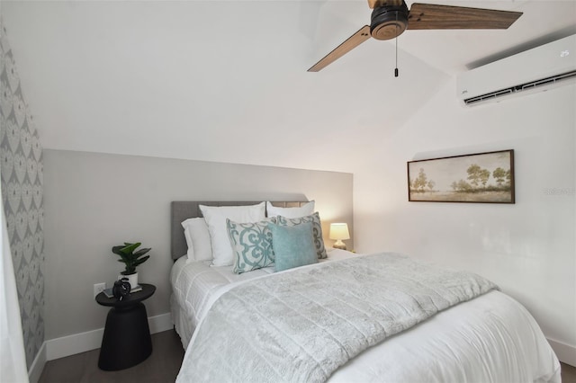 bedroom featuring hardwood / wood-style floors, a wall unit AC, ceiling fan, and lofted ceiling