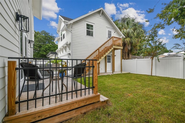 back of property featuring a yard and a deck