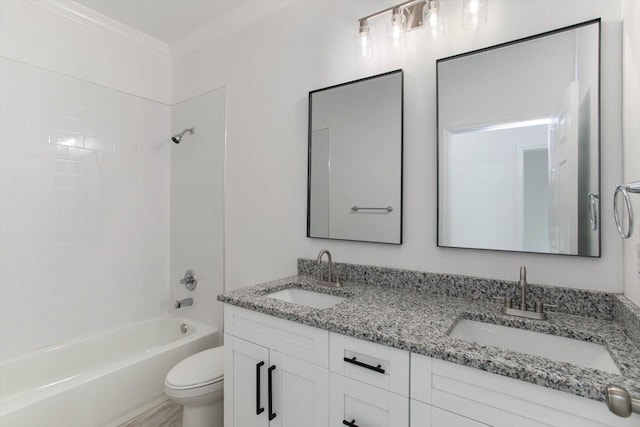 full bathroom with tiled shower / bath, crown molding, vanity, and toilet