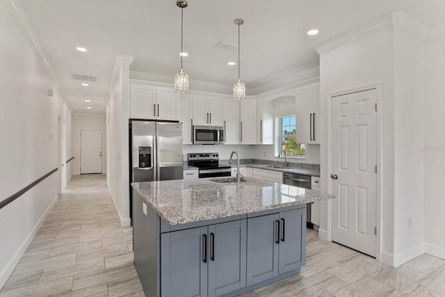 kitchen with appliances with stainless steel finishes, white cabinets, crown molding, a kitchen island with sink, and sink