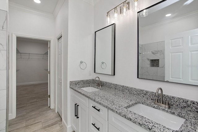 bathroom with ornamental molding, vanity, and hardwood / wood-style flooring