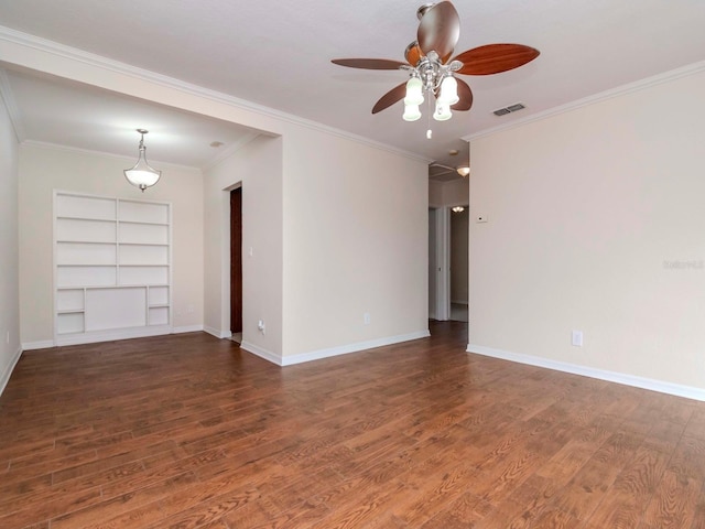 spare room with dark hardwood / wood-style flooring, ceiling fan, built in features, and ornamental molding