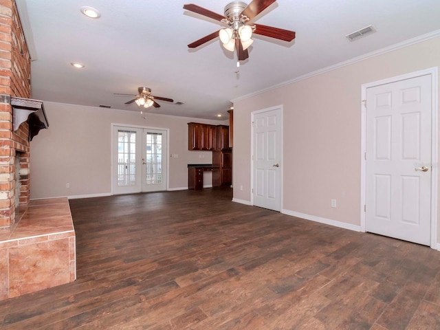 unfurnished living room featuring french doors, ceiling fan, ornamental molding, a fireplace, and dark hardwood / wood-style flooring