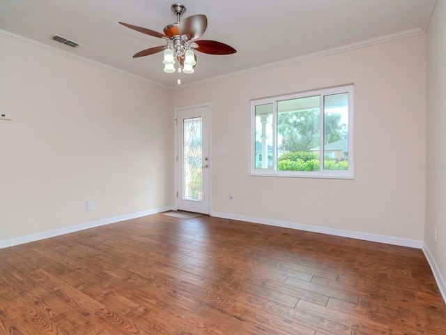 empty room featuring ceiling fan, dark hardwood / wood-style floors, and ornamental molding